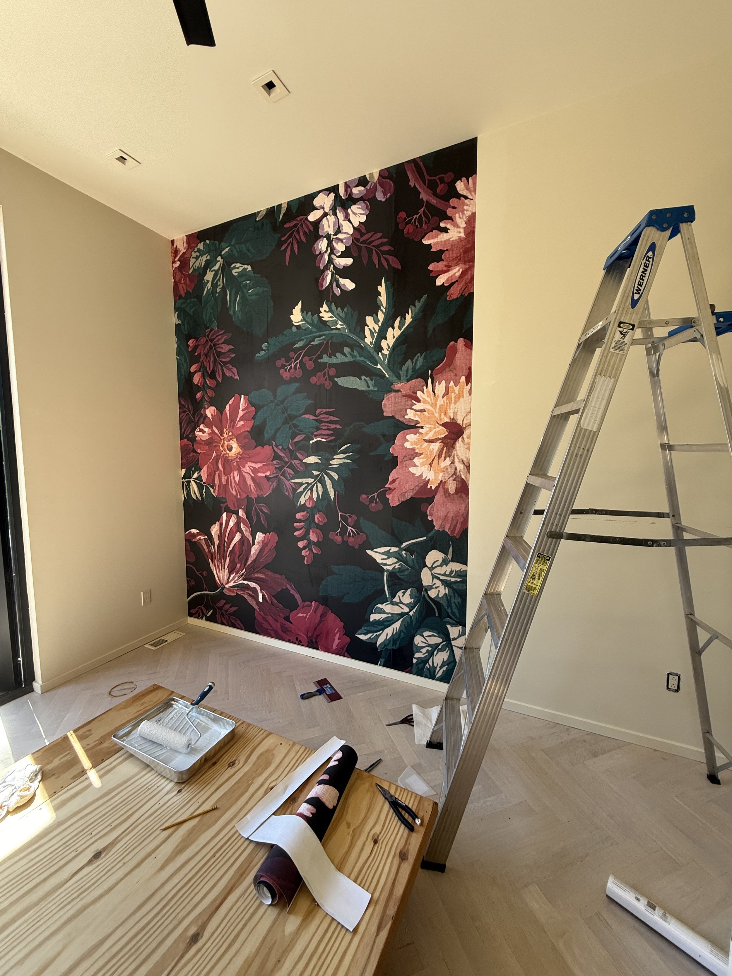 Installer working on a decorative mural wall